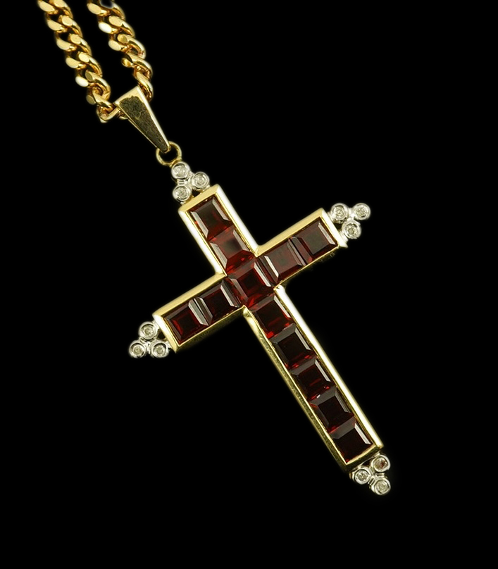 A modern 18ct gold, garnet and diamond chip cluster set cross pendant, 42mm, gross weight 6.5 grams, on a modern 9ct gold curb link chain